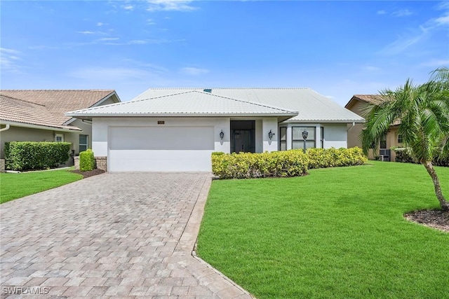 221 Saint James Way, Naples, FL 34104 - ranch-style house with decorative driveway, stucco siding, an attached garage, a front yard, and a tile roof