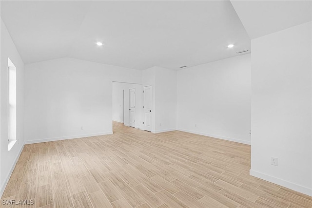 735 La Plata Ave, Lehigh Acres, FL 33974 - unfurnished room featuring light wood-type flooring, recessed lighting, and vaulted ceiling