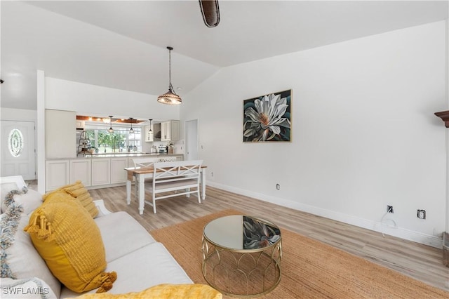 6340 P G A Dr, North Fort Myers, FL 33917 - living area with light wood-style flooring and vaulted ceiling