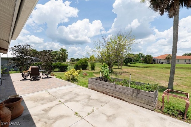 6340 P G A Dr, North Fort Myers, FL 33917 - view of patio / terrace featuring a garden and outdoor dining space