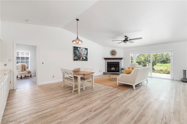 6340 P G A Dr, North Fort Myers, FL 33917 - living room with ceiling fan, light wood finished floors, a fireplace with raised hearth, and vaulted ceiling