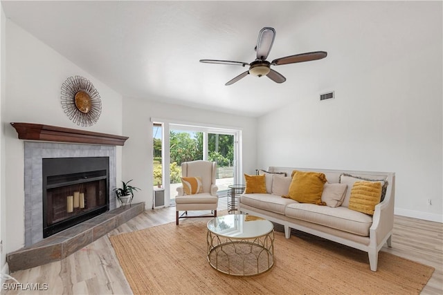 6340 P G A Dr, North Fort Myers, FL 33917 - living room with wood finished floors, a tile fireplace, lofted ceiling, and a ceiling fan