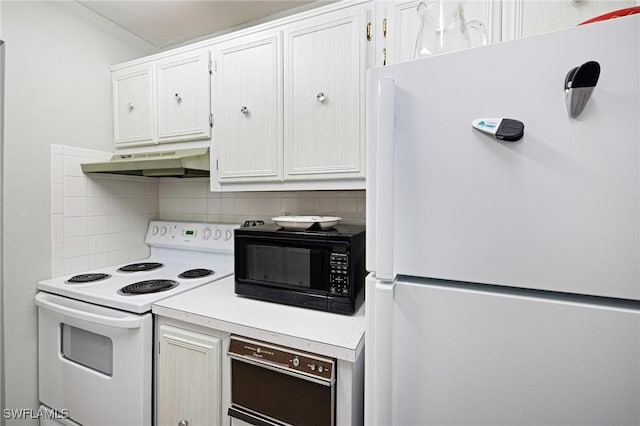 431 Van Buren St Unit B6, Fort Myers, FL 33916 - kitchen with white appliances, under cabinet range hood, tasteful backsplash, light countertops, and white cabinetry