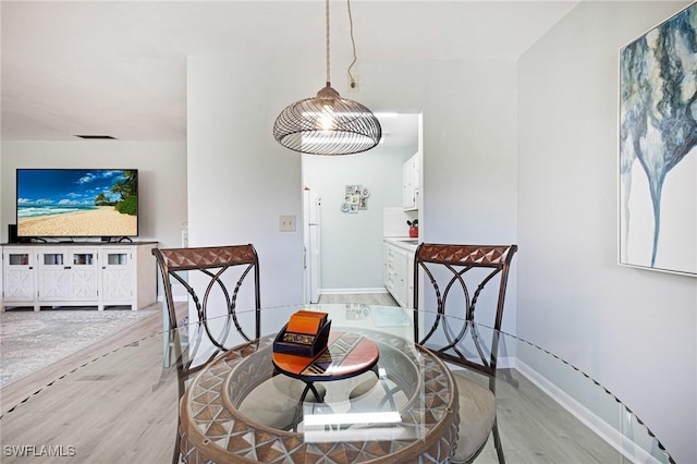 431 Van Buren St Unit B6, Fort Myers, FL 33916 - dining room featuring light wood-style flooring and baseboards