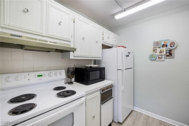 431 Van Buren St Unit B6, Fort Myers, FL 33916 - kitchen with white appliances, under cabinet range hood, decorative backsplash, light countertops, and light wood-style flooring