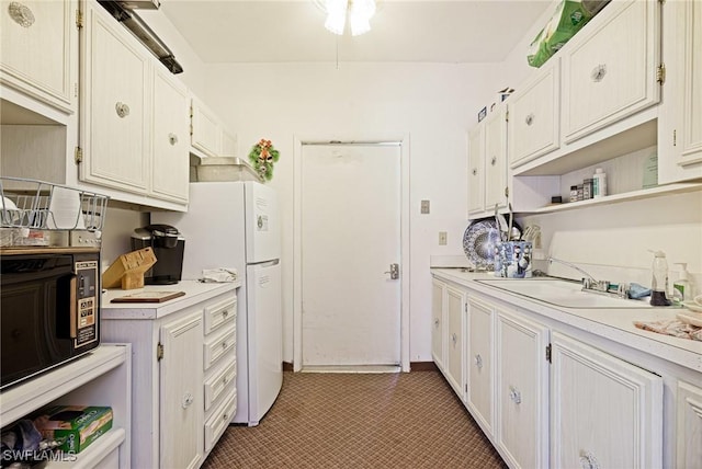 431 Van Buren St Unit B6, Fort Myers, FL 33916 - kitchen with open shelves, light countertops, freestanding refrigerator, and white cabinets