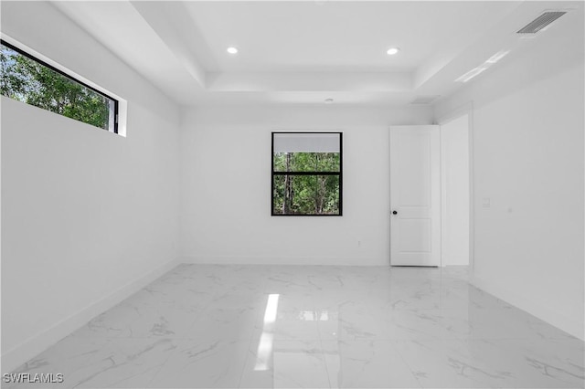 3644 35th Ave NE, Naples, FL 34120 - unfurnished room with healthy amount of natural light, a raised ceiling, recessed lighting, and marble finish flooring