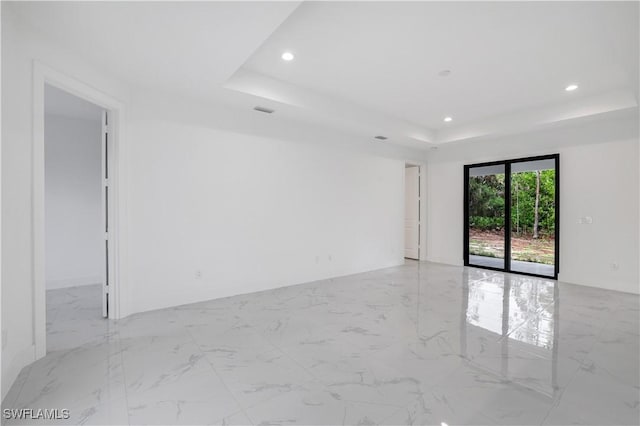 3644 35th Ave NE, Naples, FL 34120 - spare room featuring a raised ceiling, recessed lighting, and marble finish floors