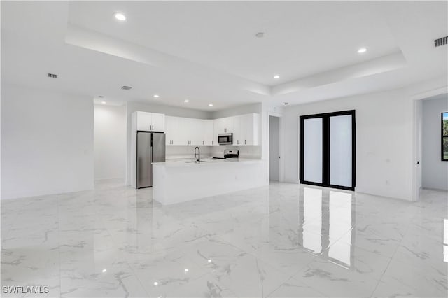 3644 35th Ave NE, Naples, FL 34120 - unfurnished living room featuring a raised ceiling, recessed lighting, and light marble finish flooring