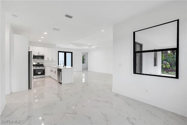 3644 35th Ave NE, Naples, FL 34120 - unfurnished living room with recessed lighting and light marble finish floors