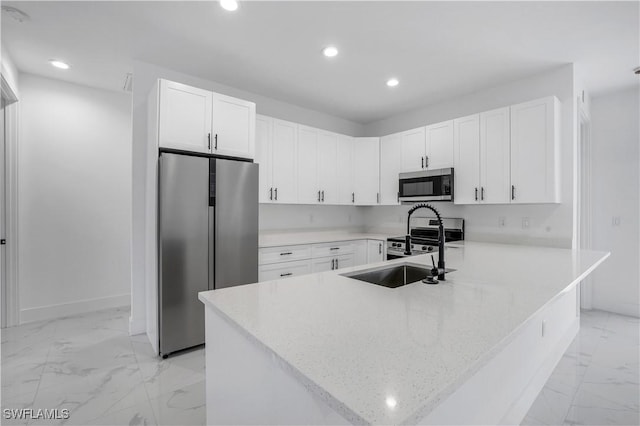 3644 35th Ave NE, Naples, FL 34120 - kitchen featuring appliances with stainless steel finishes, light marble finish flooring, recessed lighting, a peninsula, and white cabinets
