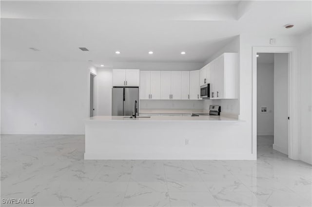 3644 35th Ave NE, Naples, FL 34120 - kitchen featuring appliances with stainless steel finishes, light countertops, white cabinetry, recessed lighting, and light marble finish flooring