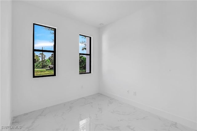 3644 35th Ave NE, Naples, FL 34120 - spare room featuring healthy amount of natural light and marble finish flooring