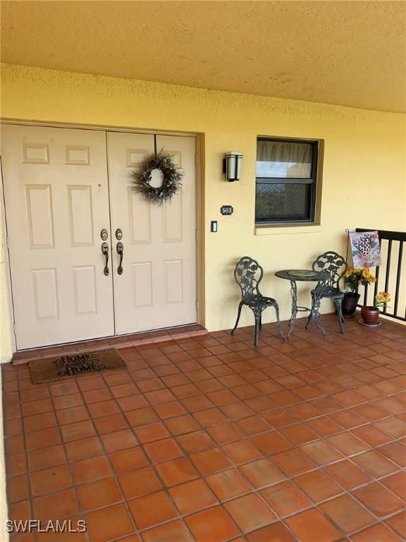 4015 SE 20th Pl Unit 503, Cape Coral, FL 33904 - entrance to property with stucco siding and covered porch