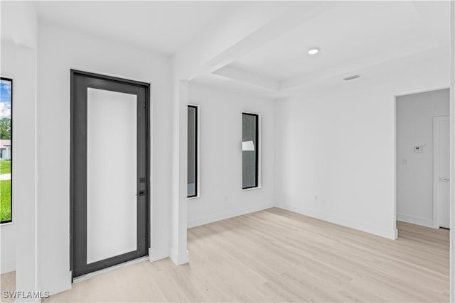 1061 Sunrise Blvd, Lehigh Acres, FL 33974 - unfurnished room featuring light wood-type flooring and a raised ceiling