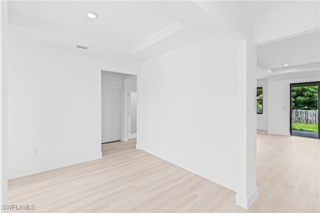 1061 Sunrise Blvd, Lehigh Acres, FL 33974 - spare room with light wood-style floors, recessed lighting, and a raised ceiling