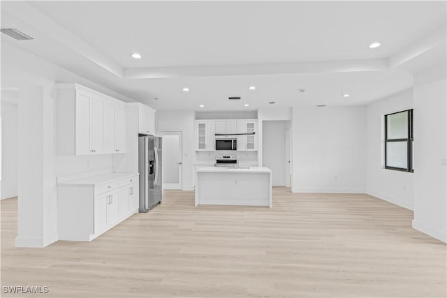 1061 Sunrise Blvd, Lehigh Acres, FL 33974 - kitchen with stainless steel appliances, light wood-style flooring, light countertops, white cabinetry, and recessed lighting