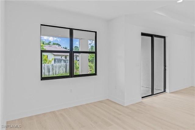1061 Sunrise Blvd, Lehigh Acres, FL 33974 - spare room featuring wood finished floors and baseboards