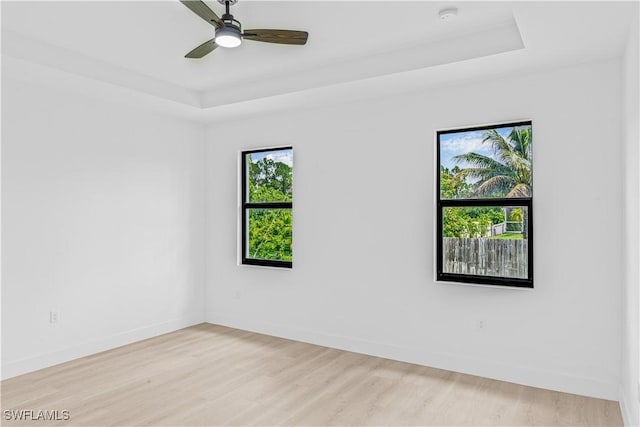 1061 Sunrise Blvd, Lehigh Acres, FL 33974 - unfurnished room featuring a raised ceiling, a smoke detector, light wood-type flooring, and ceiling fan
