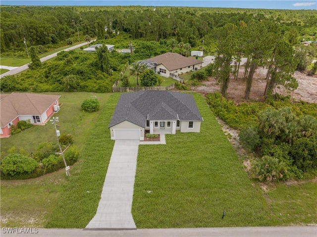 1061 Sunrise Blvd, Lehigh Acres, FL 33974 - aerial view of property and surrounding area with a heavily wooded area