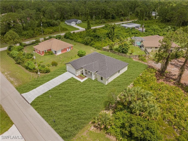 1061 Sunrise Blvd, Lehigh Acres, FL 33974 - aerial view of property and surrounding area with a forest