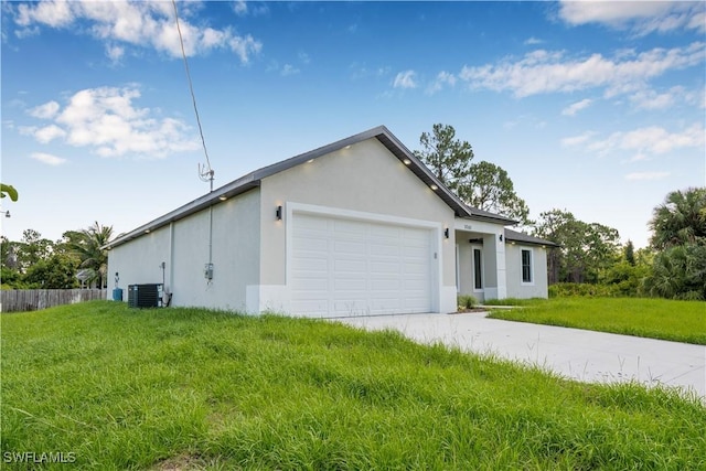 1061 Sunrise Blvd, Lehigh Acres, FL 33974 - view of side of home with stucco siding, concrete driveway, and a garage