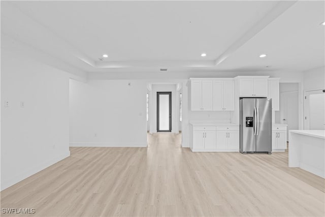1061 Sunrise Blvd, Lehigh Acres, FL 33974 - kitchen with stainless steel fridge, a tray ceiling, light wood-style flooring, light countertops, and recessed lighting