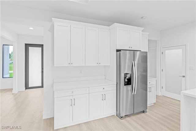 1061 Sunrise Blvd, Lehigh Acres, FL 33974 - kitchen with stainless steel refrigerator with ice dispenser, light wood finished floors, white cabinetry, and recessed lighting