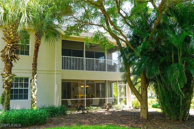 7120 Timberland Cir Unit 101, Naples, FL 34109 - rear view of house with stucco siding and a sunroom