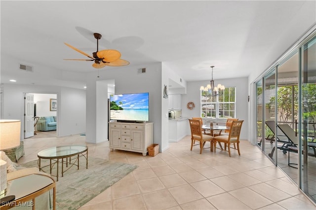 7120 Timberland Cir Unit 101, Naples, FL 34109 - living area with light tile patterned floors, a chandelier, and a ceiling fan