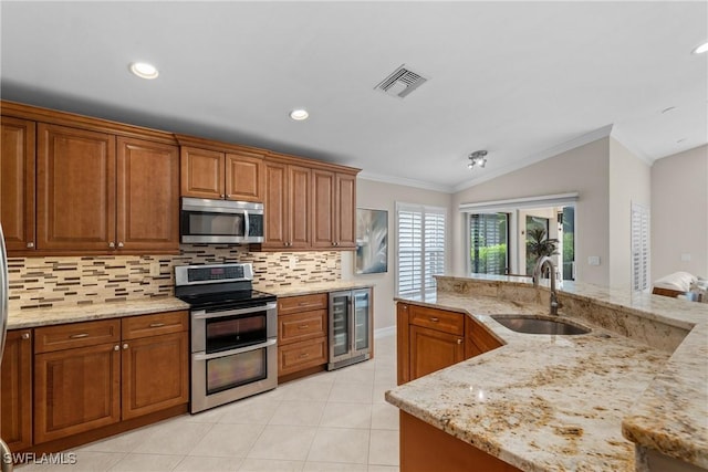 2434 Butterfly Palm Dr, Naples, FL 34119 - kitchen featuring stainless steel appliances, beverage cooler, vaulted ceiling, crown molding, and backsplash