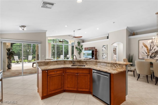 2434 Butterfly Palm Dr, Naples, FL 34119 - kitchen with stainless steel dishwasher, brown cabinetry, light tile patterned floors, light stone countertops, and vaulted ceiling