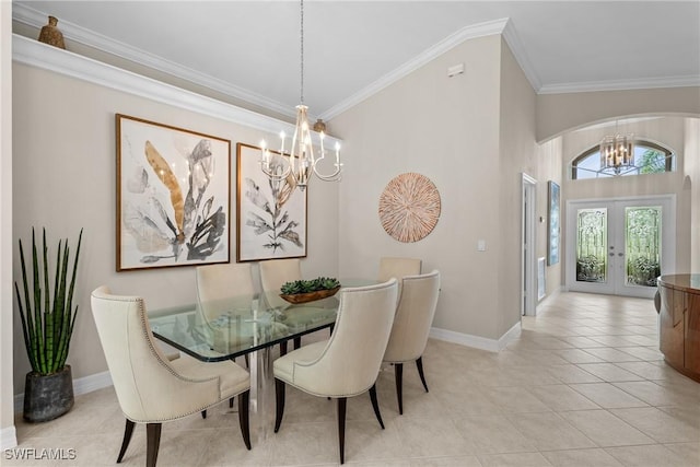 2434 Butterfly Palm Dr, Naples, FL 34119 - dining area with a chandelier, french doors, crown molding, light tile patterned floors, and arched walkways