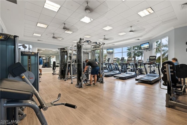 2434 Butterfly Palm Dr, Naples, FL 34119 - exercise room featuring a paneled ceiling, wood finished floors, and ornamental molding