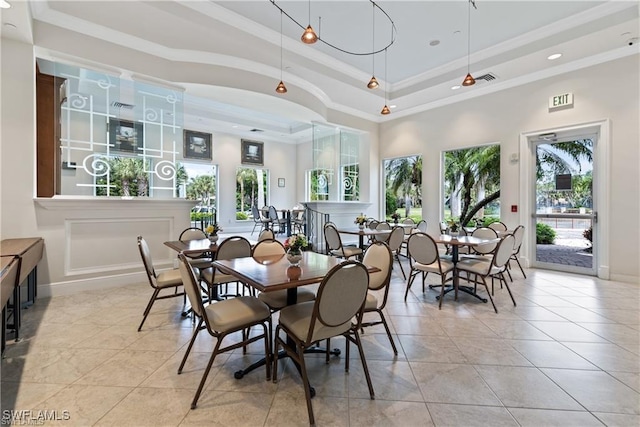 2434 Butterfly Palm Dr, Naples, FL 34119 - dining space with light tile patterned floors, a raised ceiling, crown molding, and a towering ceiling