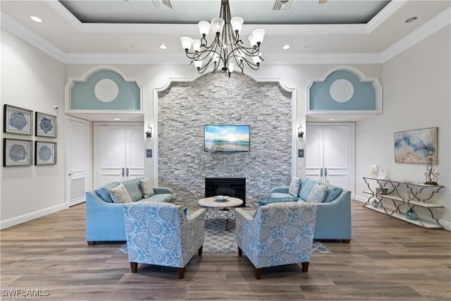 2434 Butterfly Palm Dr, Naples, FL 34119 - living room with a tray ceiling, a chandelier, wood finished floors, recessed lighting, and crown molding