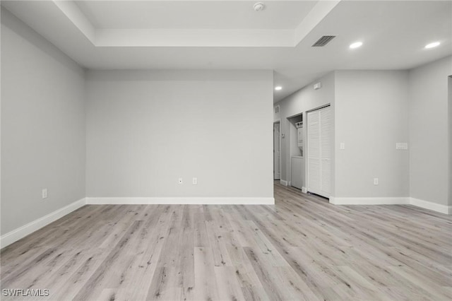 3006 72nd St W, Lehigh Acres, FL 33971 - empty room featuring light wood-style floors, recessed lighting, a raised ceiling, and a smoke detector