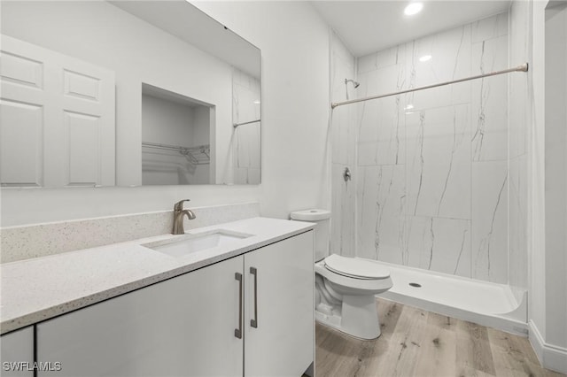 3006 72nd St W, Lehigh Acres, FL 33971 - bathroom featuring vanity, wood finished floors, a stall shower, and recessed lighting