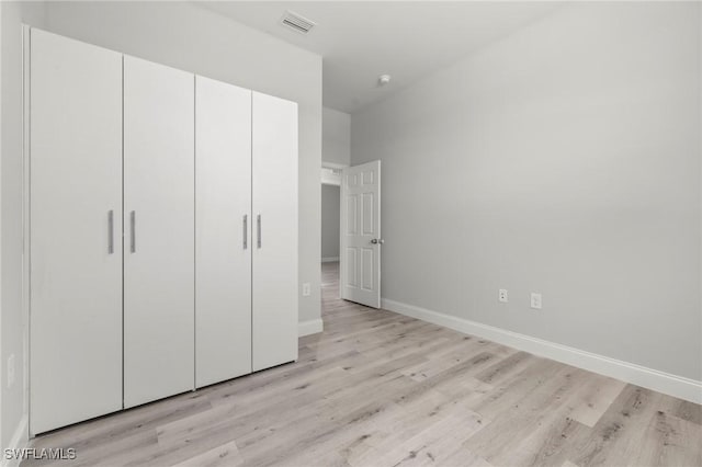 3006 72nd St W, Lehigh Acres, FL 33971 - unfurnished bedroom with light wood finished floors and a closet