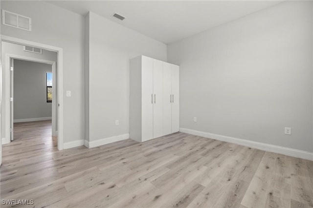 3006 72nd St W, Lehigh Acres, FL 33971 - unfurnished bedroom featuring light wood-style floors and baseboards