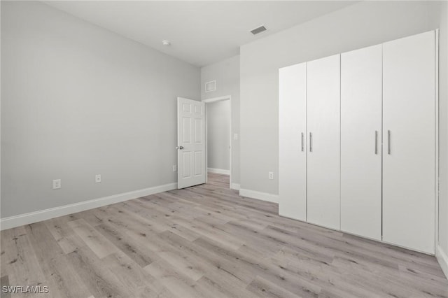 3006 72nd St W, Lehigh Acres, FL 33971 - unfurnished bedroom featuring light wood-style flooring and a closet