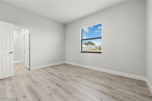 3006 72nd St W, Lehigh Acres, FL 33971 - unfurnished bedroom with light wood-type flooring and baseboards