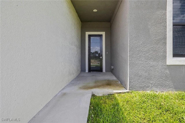 3006 72nd St W, Lehigh Acres, FL 33971 - doorway to property with stucco siding