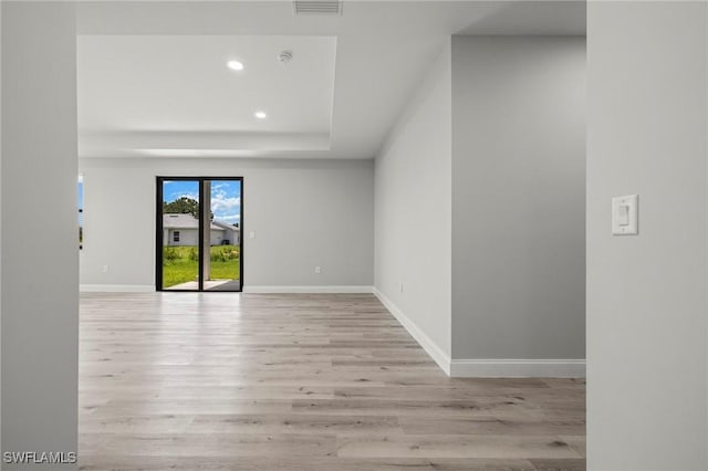 3006 72nd St W, Lehigh Acres, FL 33971 - empty room featuring wood finished floors, recessed lighting, a raised ceiling, and a smoke detector
