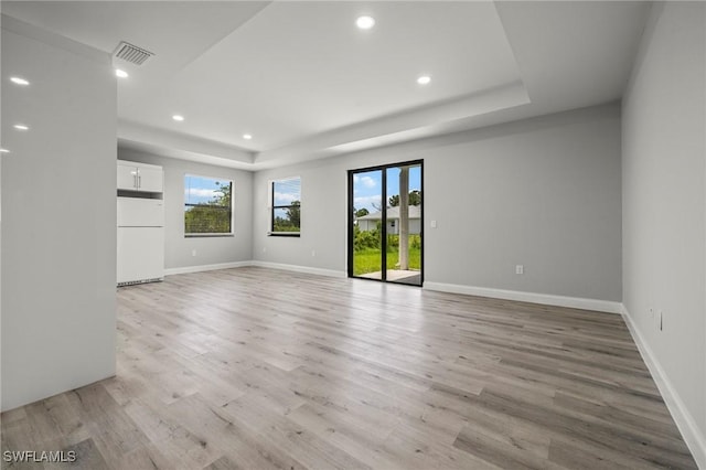 3006 72nd St W, Lehigh Acres, FL 33971 - unfurnished room with a raised ceiling, light wood finished floors, and recessed lighting