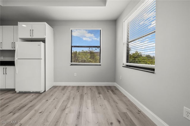 3006 72nd St W, Lehigh Acres, FL 33971 - unfurnished dining area featuring light wood-style flooring and baseboards