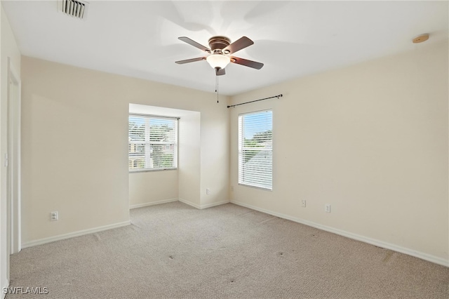 10043 Winding River Rd, Punta Gorda, FL 33950 - spare room featuring light carpet, a ceiling fan, and a smoke detector