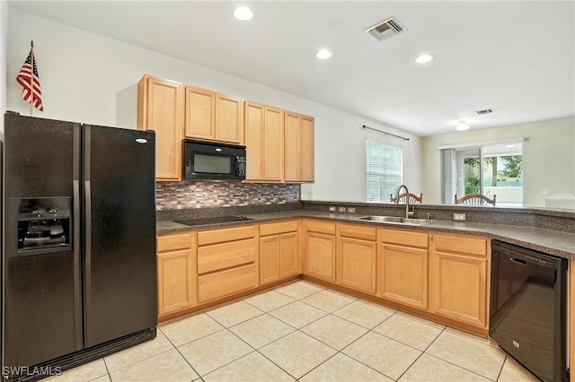 10043 Winding River Rd, Punta Gorda, FL 33950 - kitchen with black appliances, light brown cabinetry, light tile patterned floors, dark countertops, and recessed lighting