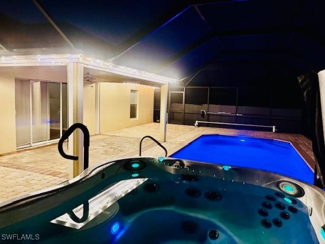 2116 NW 24th Ave, Cape Coral, FL 33993 - outdoor pool featuring a hot tub, a patio area, and a ceiling fan