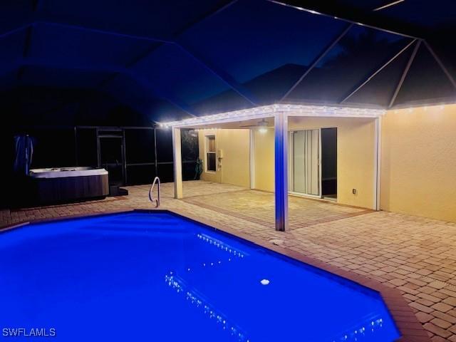 2116 NW 24th Ave, Cape Coral, FL 33993 - outdoor pool featuring a hot tub, a patio area, and glass enclosure